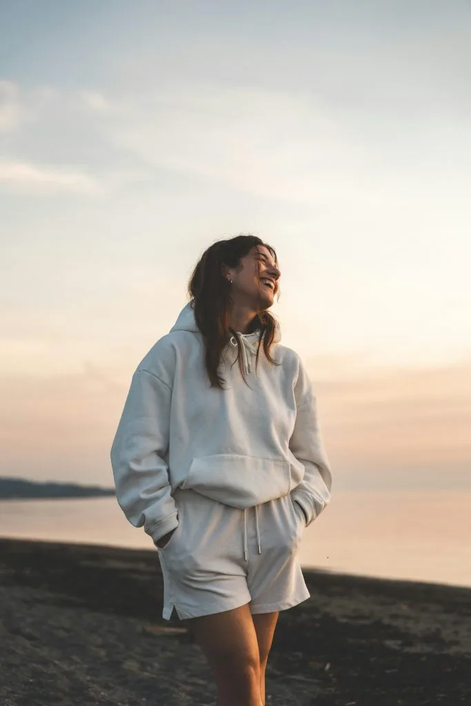 Woman walking on a beach at sunset